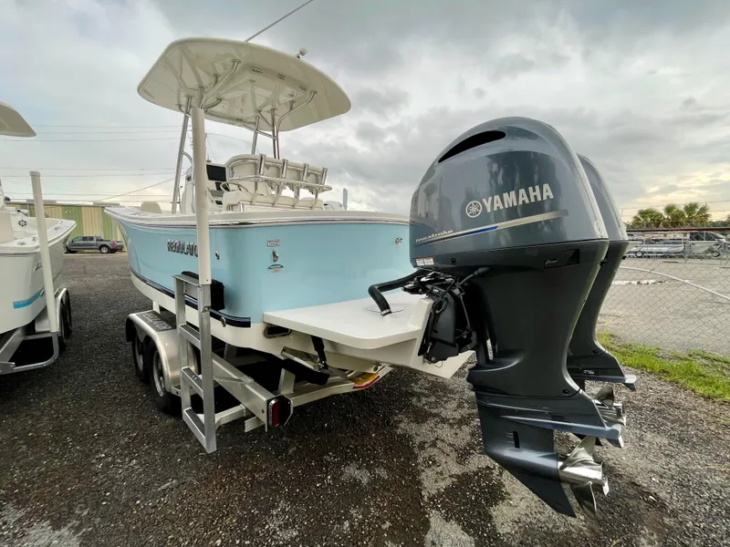 Slide: The Image of 2019 Regulator 23 boat with Yamaha outboard motor on trailer. - 4