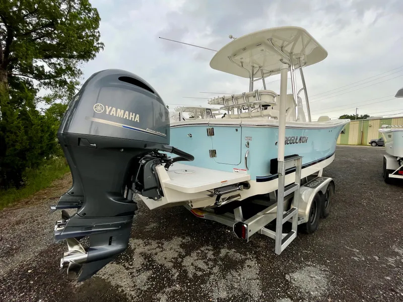Slide: The Image of 2019 Regulator 23 boat with Yamaha outboard engine on a trailer. - 6