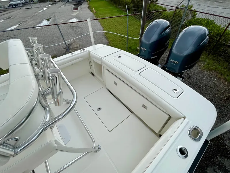 Slide: The Image of 2019 Regulator 23 boat with dual Yamaha 150 engines, spacious deck, and rod holders. - 9