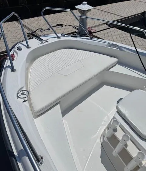 Slide: The Image of 2012 Boston Whaler 180 Dauntless boat interior with white seating and railings. - 11