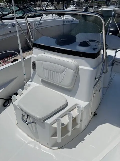 Slide: The Image of 2012 Boston Whaler 180 Dauntless boat interior with seating and rod holders. - 14