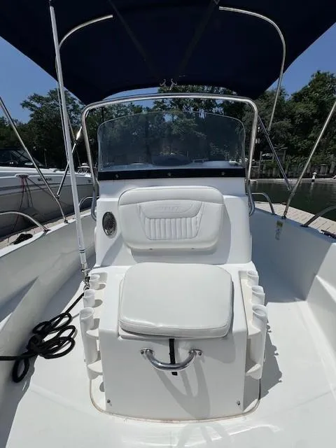 Slide: The Image of 2012 Boston Whaler 180 Dauntless boat interior with seating and canopy. - 15