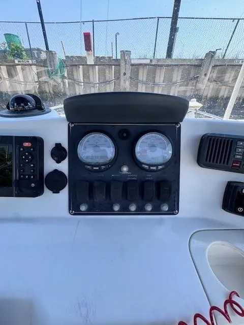 Slide: The Image of Control panel of a 2012 Boston Whaler 180 Dauntless boat with gauges and switches. - 16