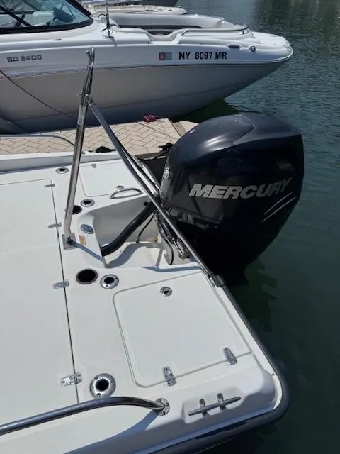 Slide: The Image of 2012 Boston Whaler 180 Dauntless with Mercury outboard engine, docked on calm water. - 20