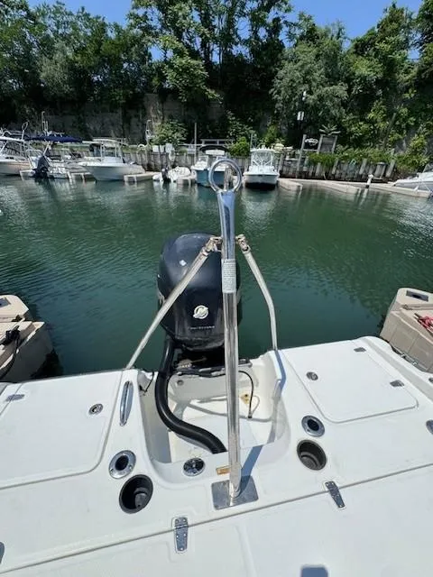 Slide: The Image of 2012 Boston Whaler 180 Dauntless boat docked in a marina with surrounding trees. - 22