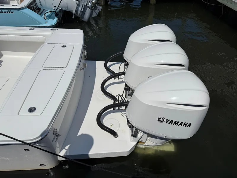 Slide: The Image of 2017 Regulator 34SS boat with triple Yamaha outboard engines docked in water. - 16