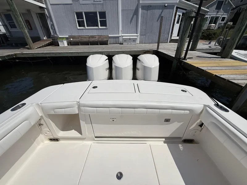 Slide: The Image of 2017 Regulator 34SS boat with triple outboard engines docked at marina. - 17