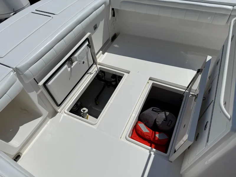 Slide: The Image of 2017 Regulator 34SS boat storage compartments with safety gear and equipment. - 23