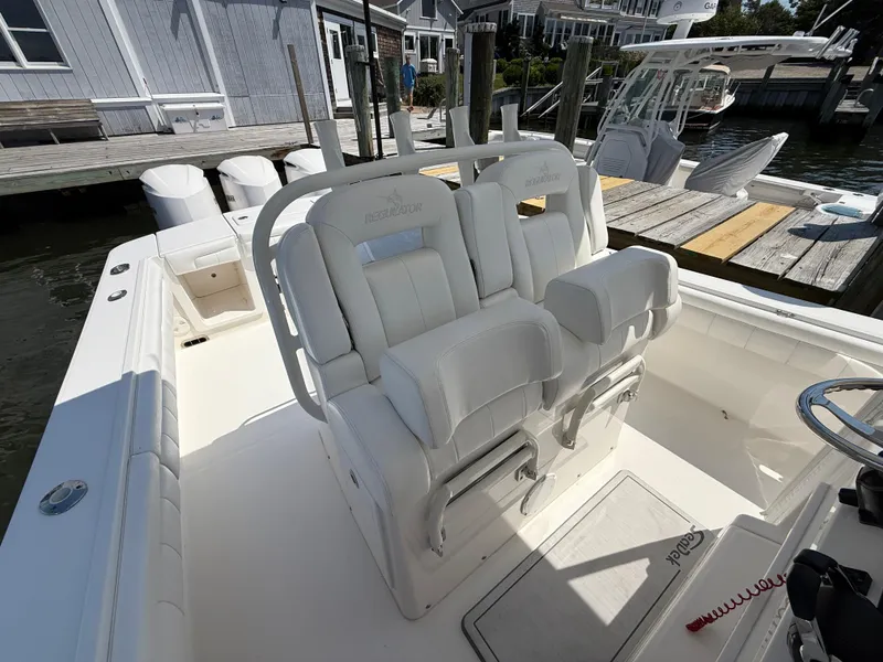 Slide: The Image of 2017 Regulator 34SS boat with white seating and docked at a marina. - 30