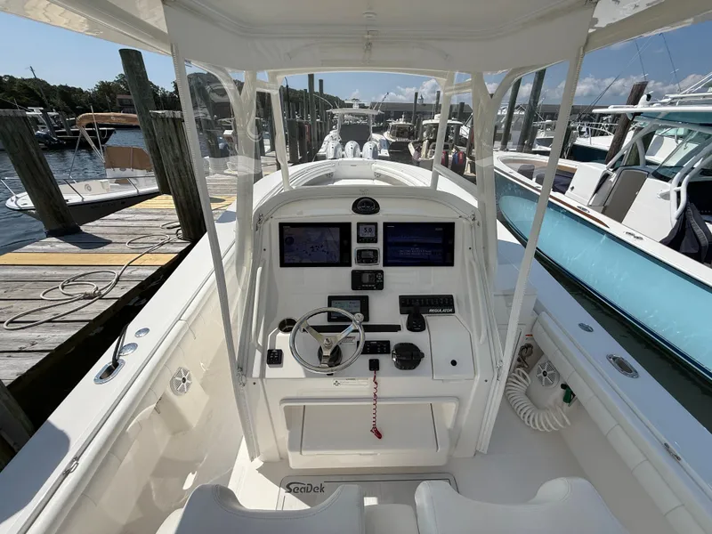 Slide: The Image of 2017 Regulator 34SS boat cockpit with modern navigation equipment at a marina. - 33
