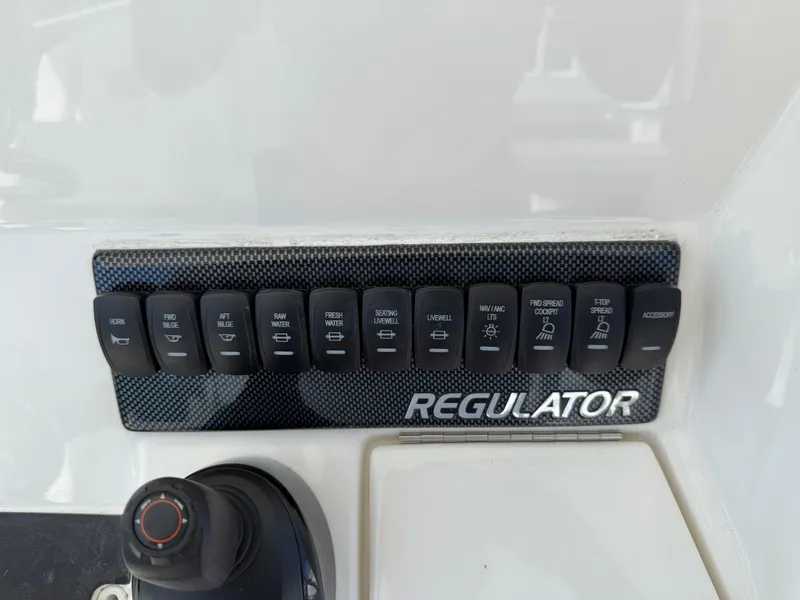 Slide: The Image of Control panel of a 2017 Regulator 34SS boat with labeled switches. - 37