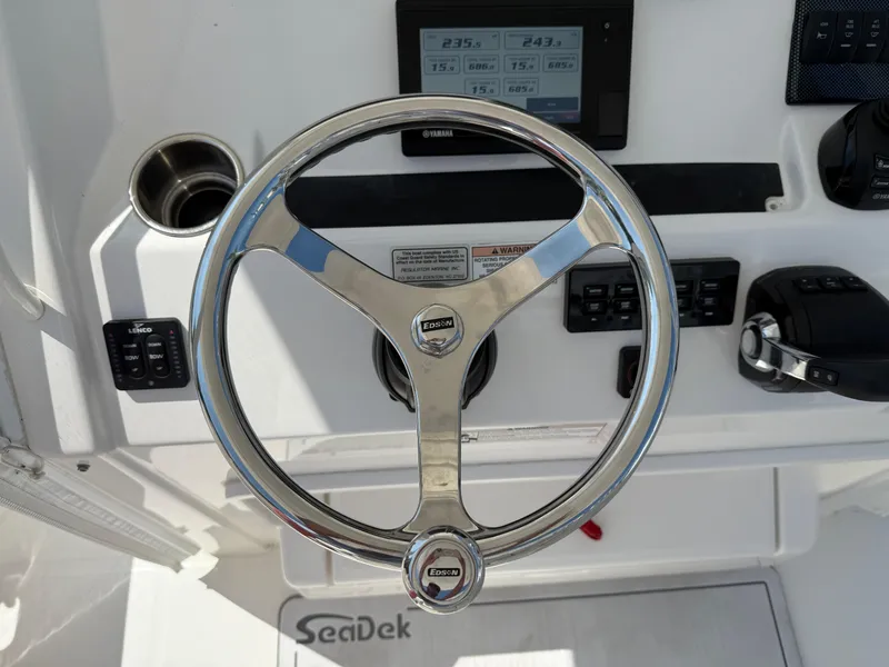 Slide: The Image of Steering wheel of 2017 Regulator 34SS boat with control panel and SeaDek flooring. - 39