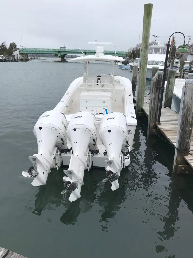 Slide: The Image of 2017 Regulator 34SS boat with triple outboard engines docked in marina. - 4