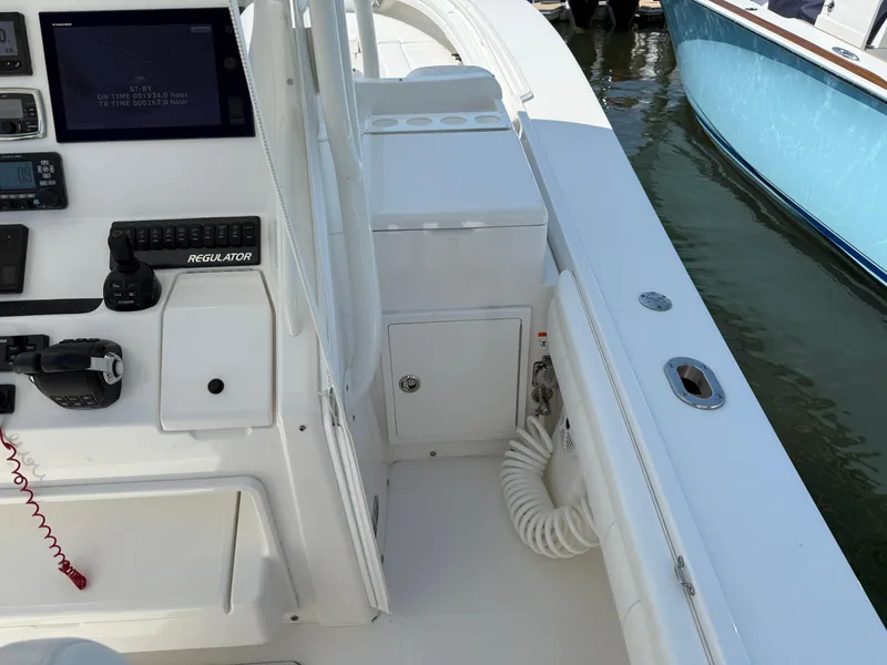 Slide: The Image of 2017 Regulator 34SS boat cockpit with control panel and seating area. - 41