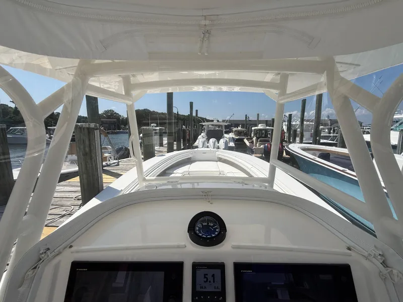 Slide: The Image of 2017 Regulator 34SS boat docked at marina, view from helm. - 42