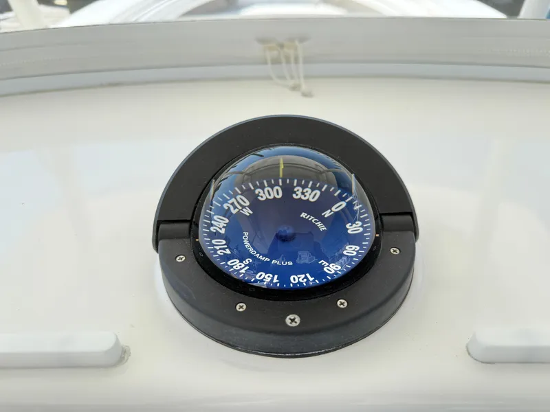 Slide: The Image of Compass on 2017 Regulator 34SS boat dashboard, displaying navigation directions. - 43
