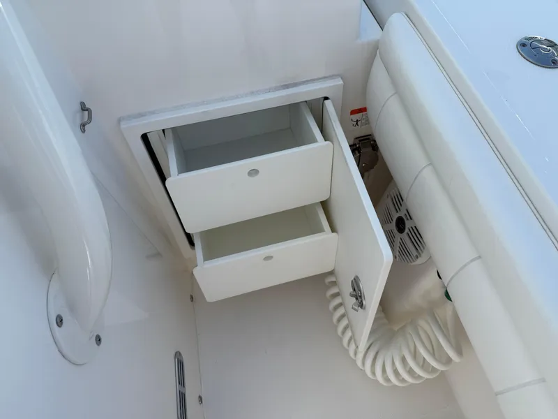 Slide: The Image of Open storage drawers on a 2017 Regulator 34SS boat, showcasing interior organization. - 44