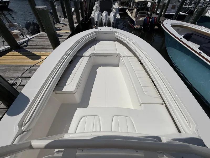 Slide: The Image of 2017 Regulator 34SS boat with spacious seating, docked at a marina. - 48