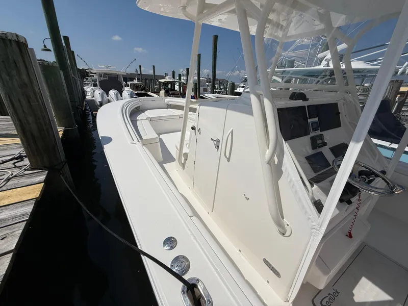 Slide: The Image of 2017 Regulator 34SS boat docked, featuring a sleek console and spacious deck. - 49