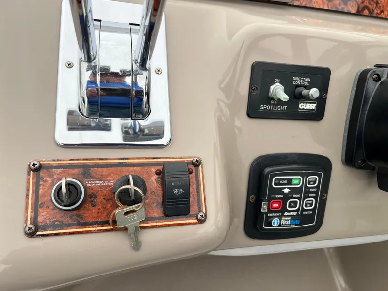 Slide: The Image of Control panel of a 2004 Wellcraft 3700 Martinique boat with keys and switches. - 12