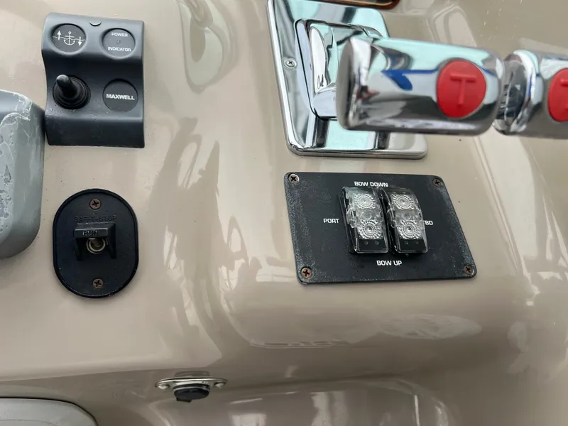 Slide: The Image of Control panel of a 2004 Wellcraft 3700 Martinique boat with switches and levers. - 13