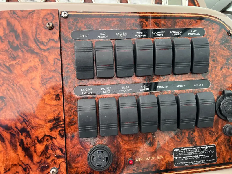 Slide: The Image of Control panel of a 2004 Wellcraft 3700 Martinique boat with various switches and labels. - 14
