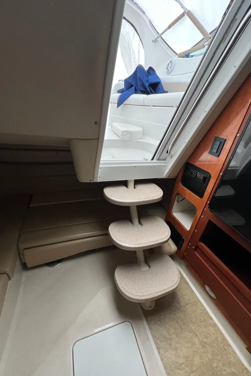 Slide: The Image of Interior view of 2004 Wellcraft 3700 Martinique yacht with spiral stairs and seating area. - 16