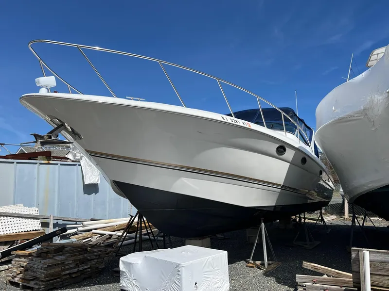 Slide: The Image of 2004 Wellcraft 3700 Martinique boat on stands, clear sky background. - 2