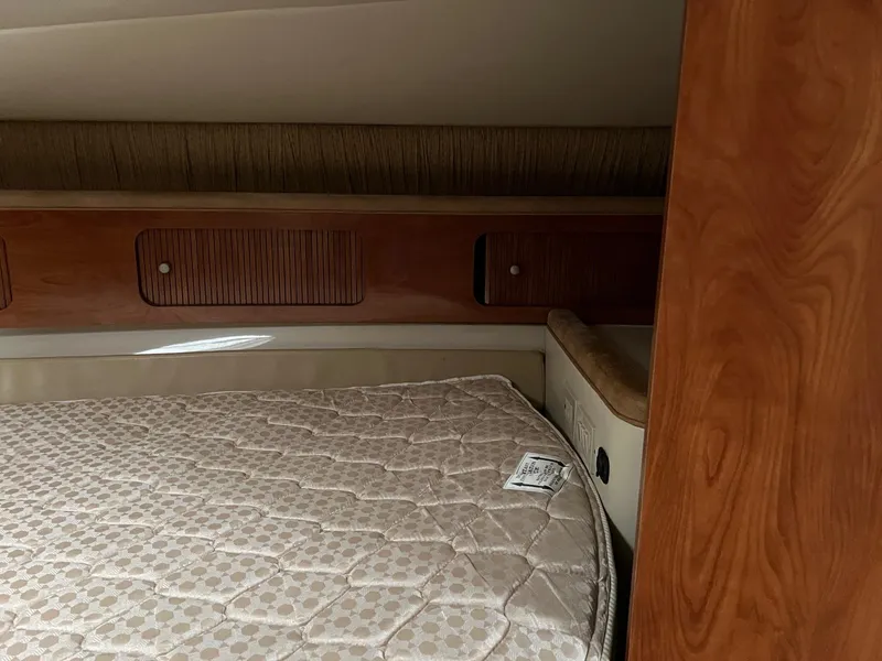 Slide: The Image of Interior cabin of 2004 Wellcraft 3700 Martinique with wooden paneling and mattress. - 23