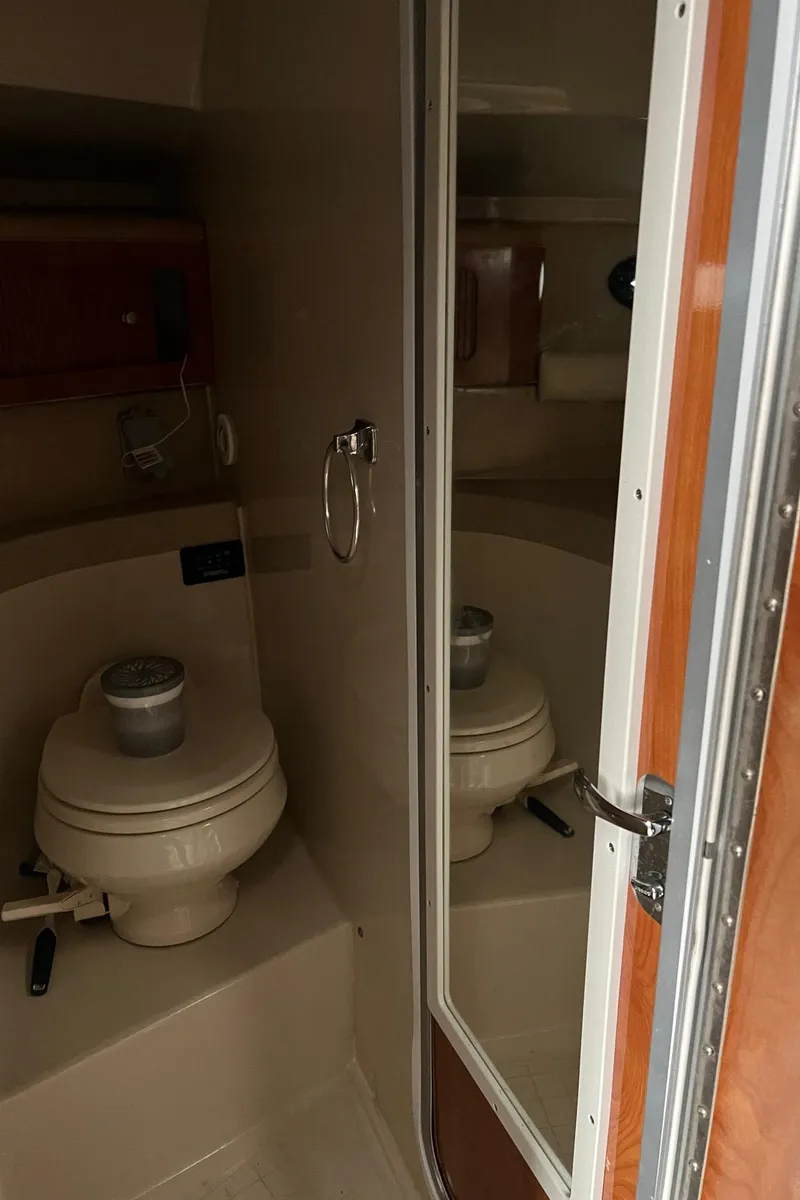 Slide: The Image of 2004 Wellcraft 3700 Martinique boat bathroom interior with toilet and mirror. - 24