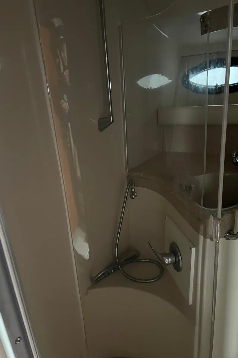 Slide: The Image of Interior of 2004 Wellcraft 3700 Martinique boat bathroom with shower and sink. - 25
