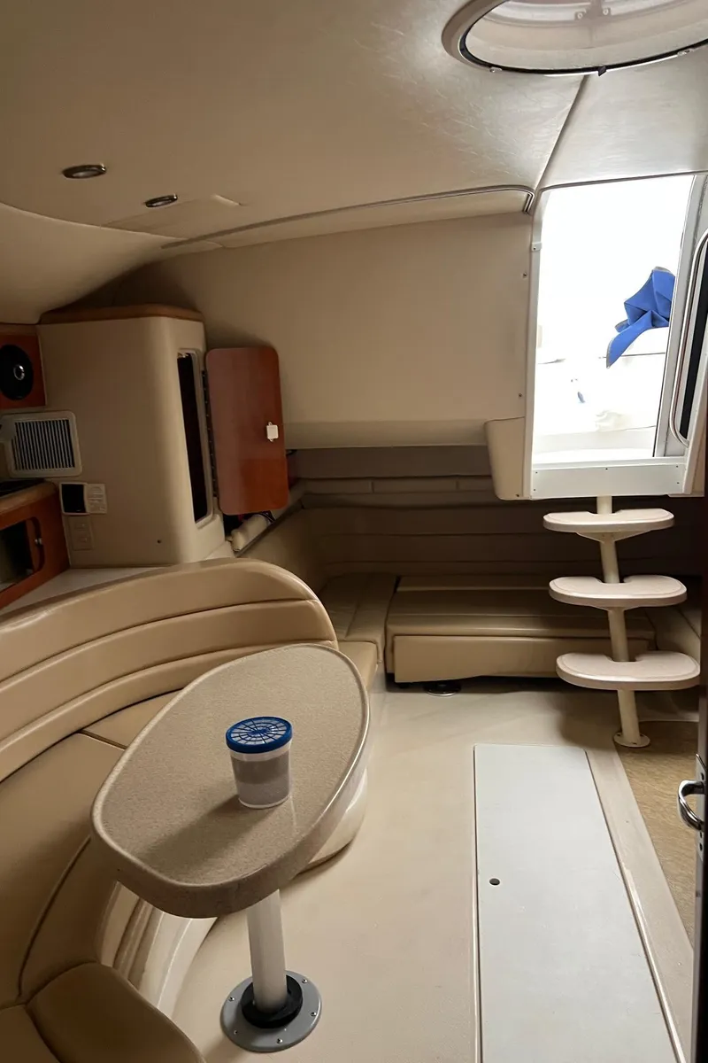 Slide: The Image of Interior of 2004 Wellcraft 3700 Martinique boat with beige seating and table. - 26
