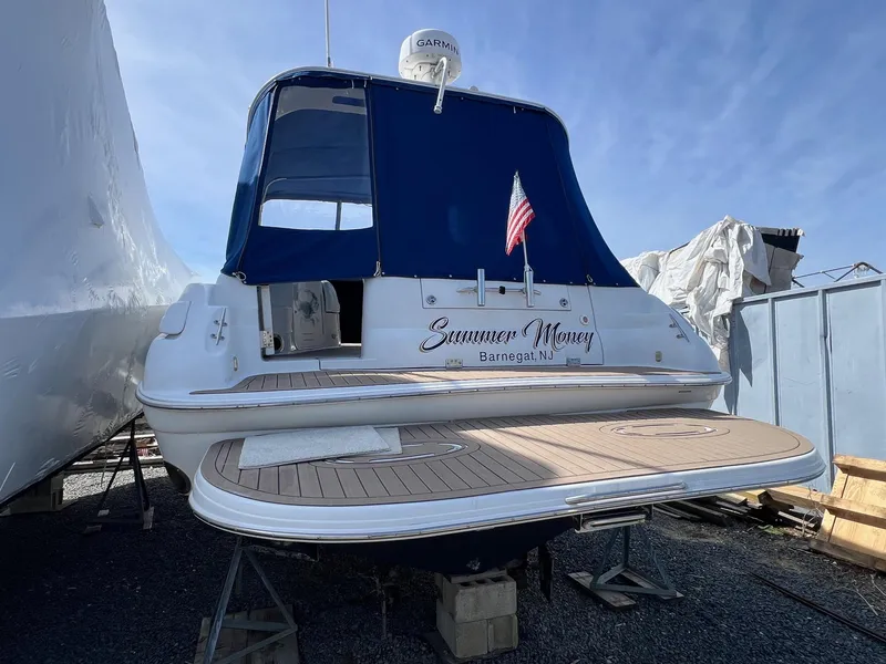 Slide: The Image of 2004 Wellcraft 3700 Martinique boat with blue canopy and American flag, docked in Barnegat, NJ. - 3