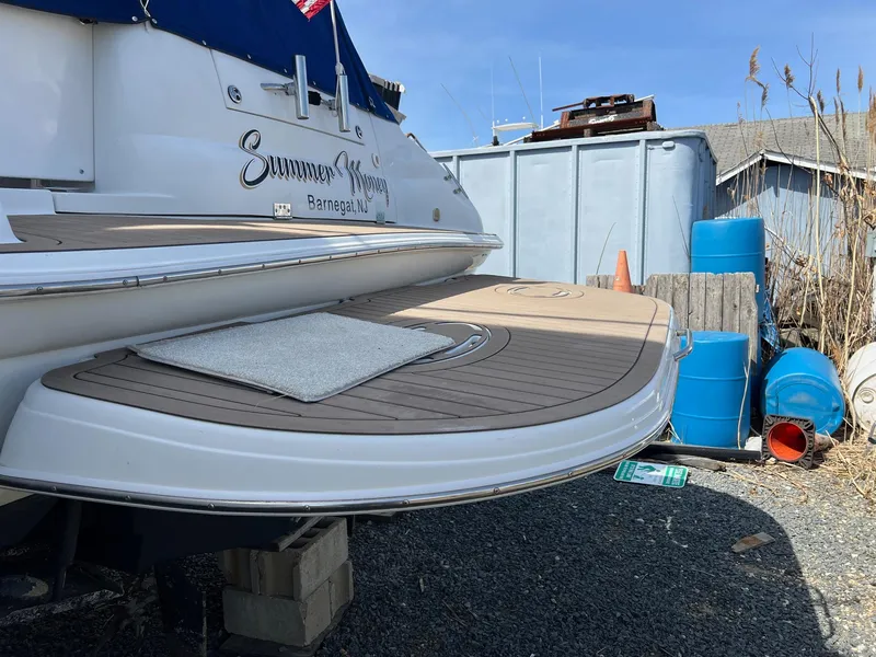 Slide: The Image of 2004 Wellcraft 3700 Martinique boat docked, featuring a spacious deck area. - 5