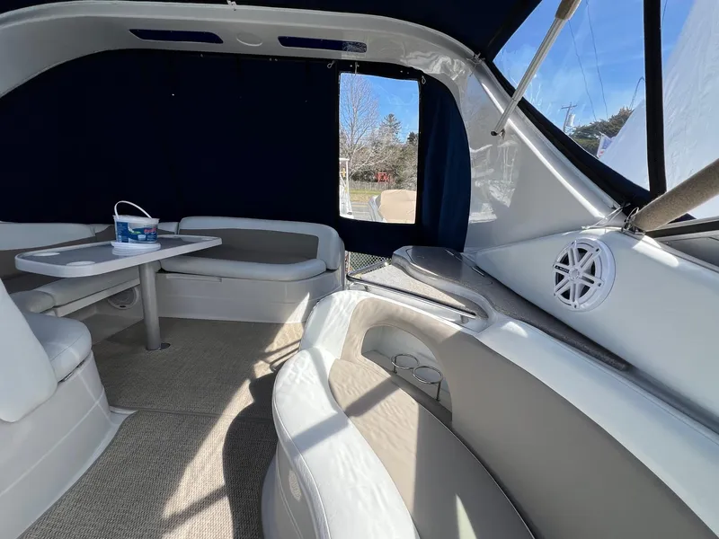 Slide: The Image of 2004 Wellcraft 3700 Martinique boat interior with seating, table, and speaker. - 8