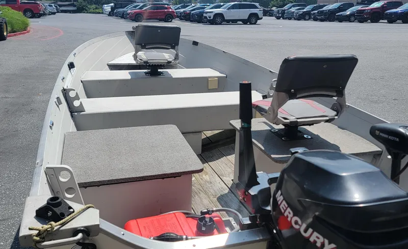 Slide: The Image of 2010 Starcraft SF 1415 boat with Mercury motor in parking lot. - 5