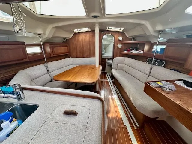 Slide: The Image of Interior of 1993 Hunter Legend 40.5 sailboat with cozy seating and wooden accents. - 10