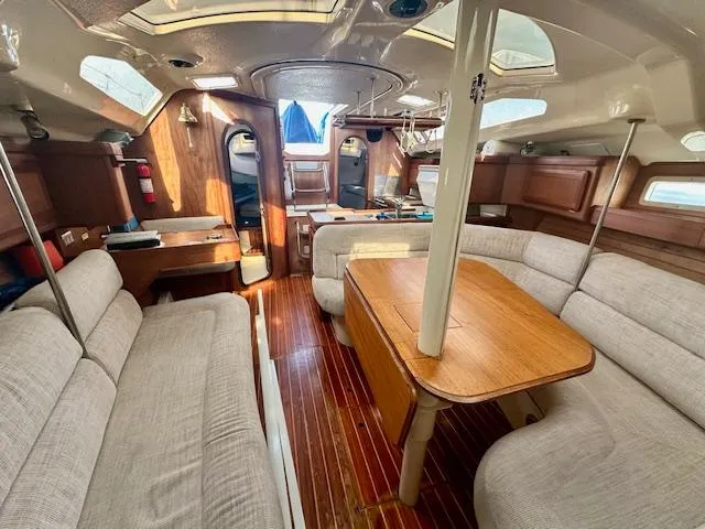 Slide: The Image of Interior of 1993 Hunter Legend 40.5 sailboat with wood accents and beige seating. - 11