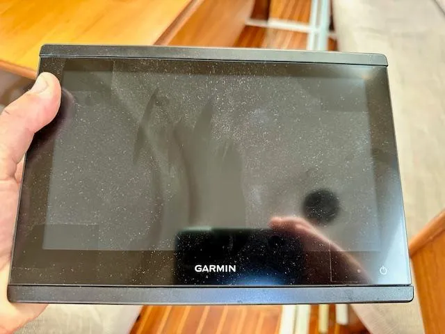 Slide: The Image of Hand holding a Garmin navigation device, likely used on a 1993 Hunter Legend 40.5 boat. - 22