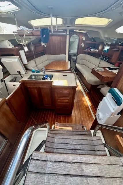 Slide: The Image of Interior of a 1993 Hunter Legend 40.5 sailboat with wooden furnishings and seating area. - 23