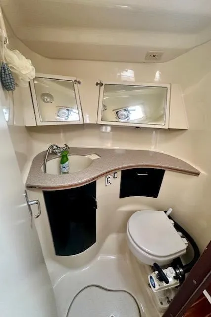 Slide: The Image of 1993 Hunter Legend 40.5 yacht bathroom with sink, mirrors, and toilet. - 25