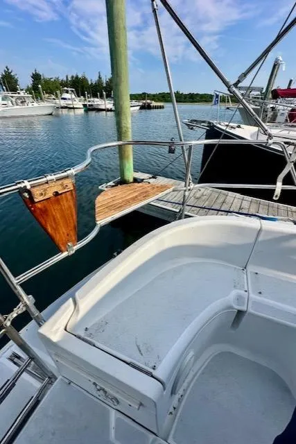Slide: The Image of 1993 Hunter Legend 40.5 sailboat docked at a marina, featuring a spacious cockpit. - 30