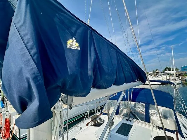 Slide: The Image of Sailboat with blue Doyle sail cover, Hunter Legend 40.5, 1993 model, docked under clear sky. - 36