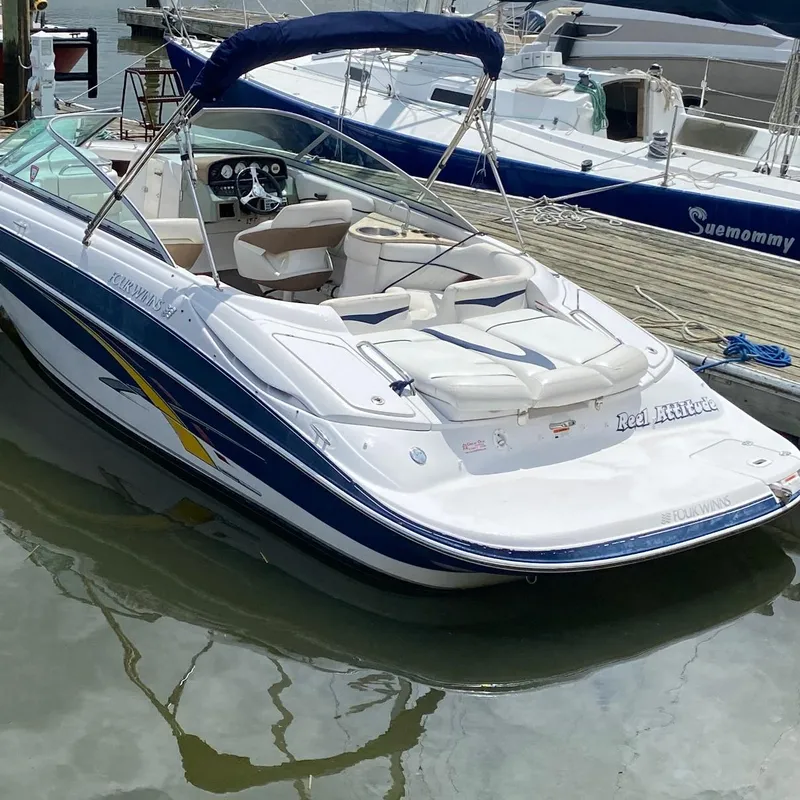 The Image of 2007 Four Winns 240 Horizon boat docked in marina, featuring sleek design and comfortable seating. - 0