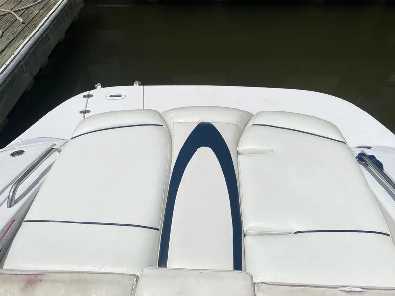 Slide: The Image of 2007 Four Winns 240 Horizon boat with white and blue seating at dock. - 13