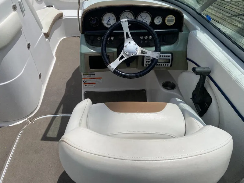 Slide: The Image of 2007 Four Winns 240 Horizon boat cockpit with steering wheel and gauges. - 18