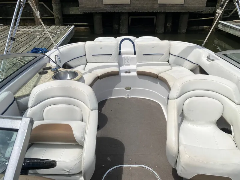 Slide: The Image of 2007 Four Winns 240 Horizon boat interior with white seating and a built-in sink. - 2