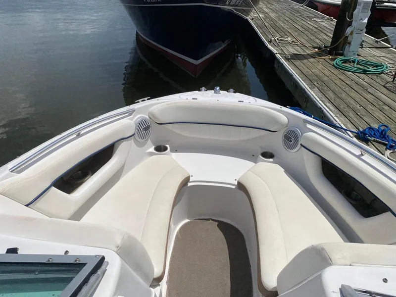 Slide: The Image of 2007 Four Winns 240 Horizon boat interior with white seating, docked by wooden pier. - 3
