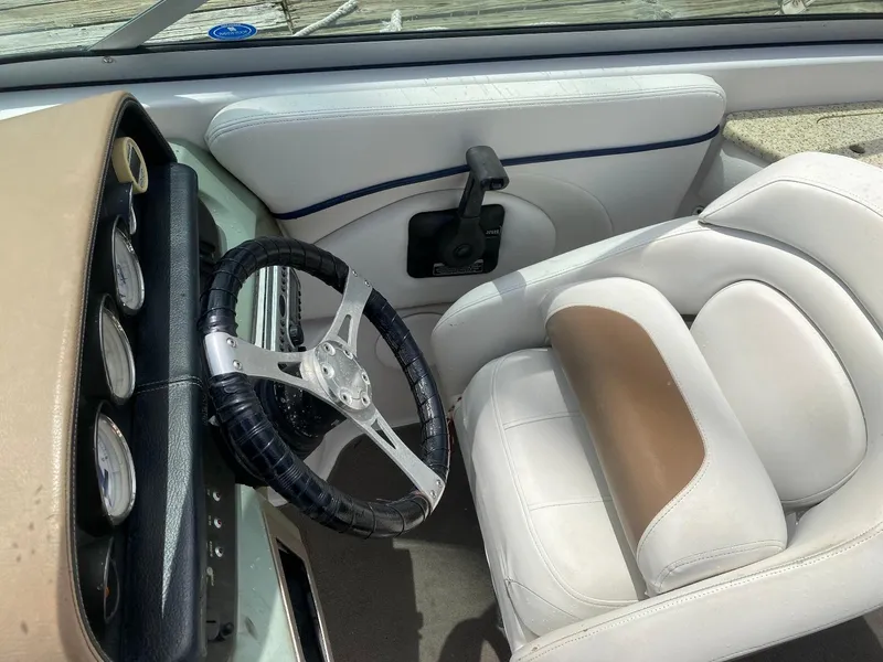 Slide: The Image of 2007 Four Winns 240 Horizon boat interior with steering wheel and white seating. - 6