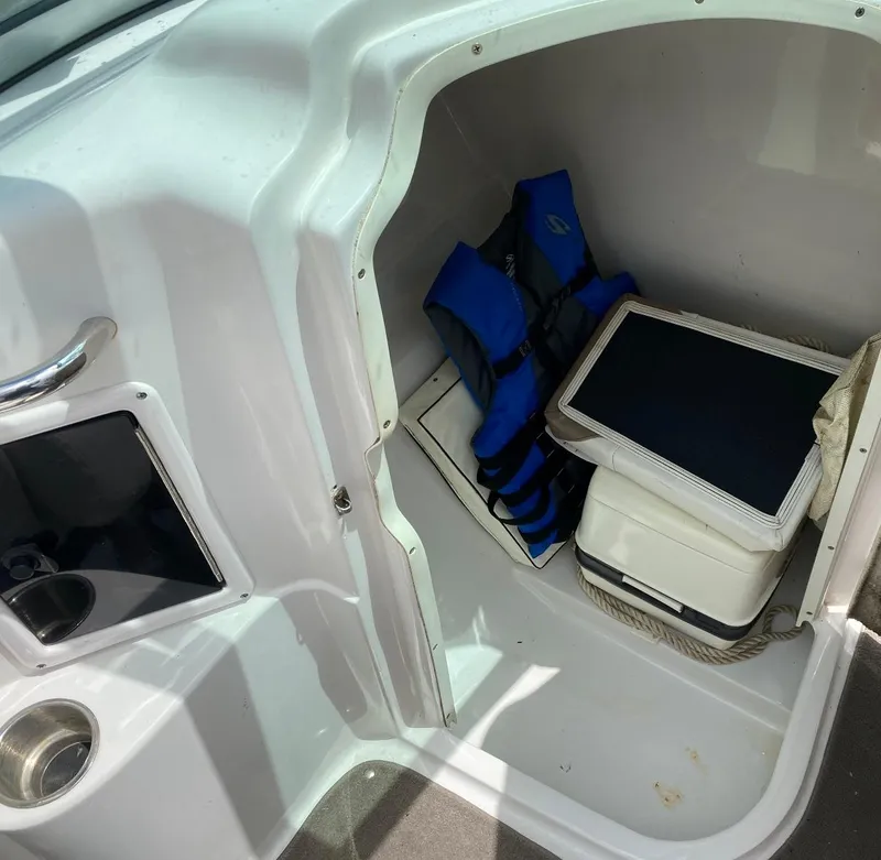 Slide: The Image of Storage compartment in a 2007 Four Winns 240 Horizon boat with life jackets and cooler. - 9